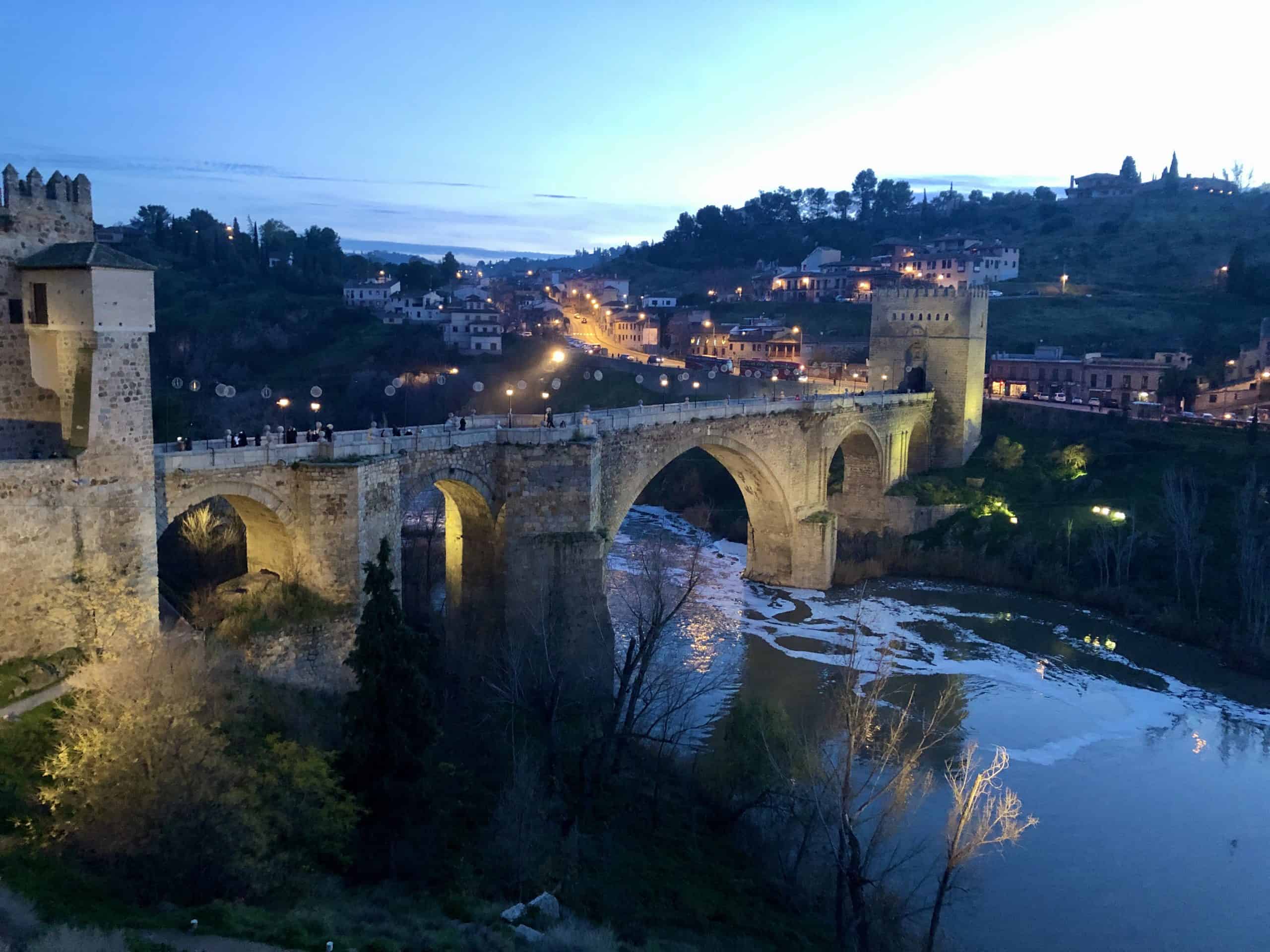 Downtown Toledo, Spain in winter. View of San Martin bridge and the Tagus River in the evening.